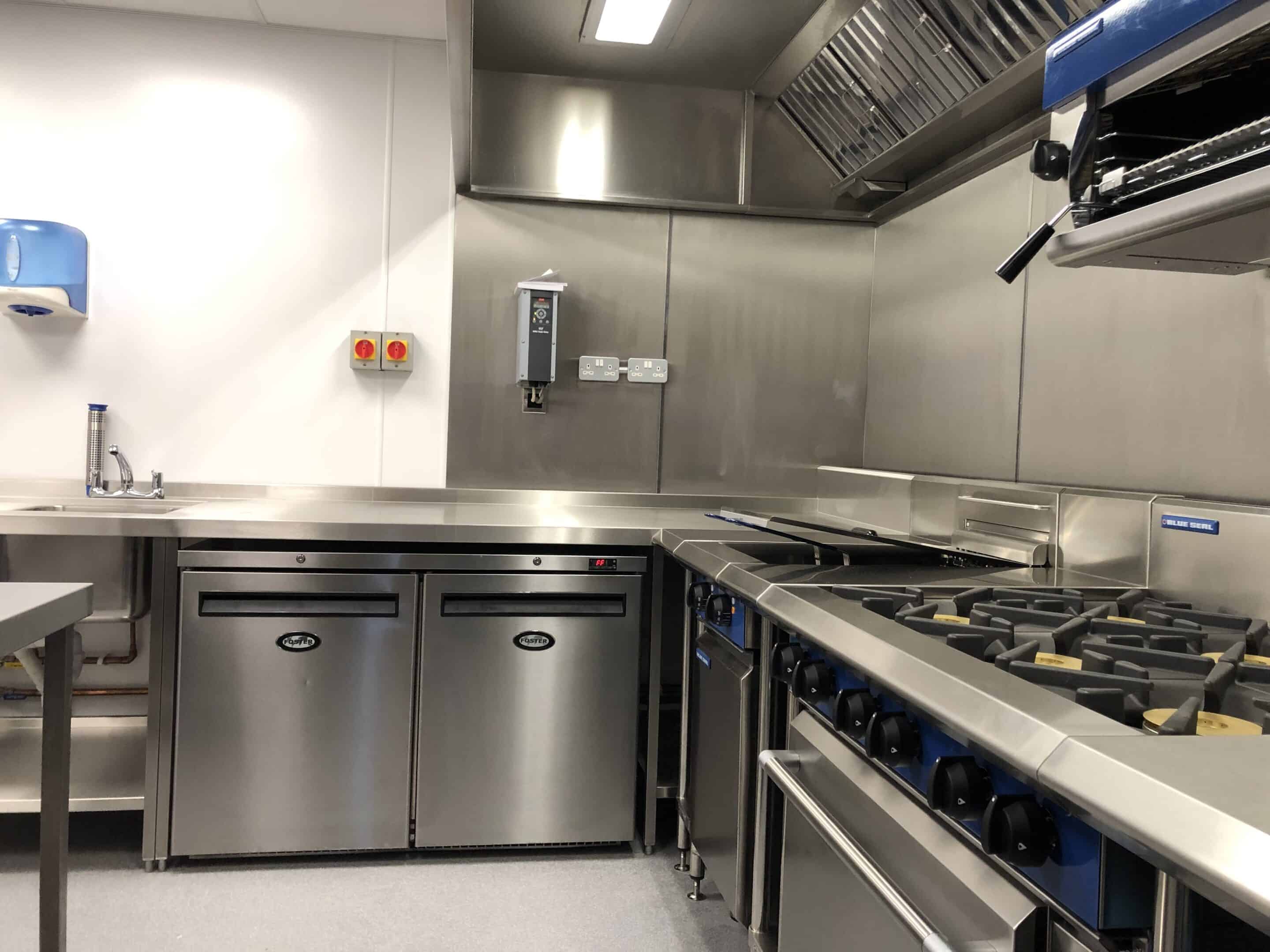 Rational SCC combi oven and gas range under extraction canopy at Deal Pier Kitchen