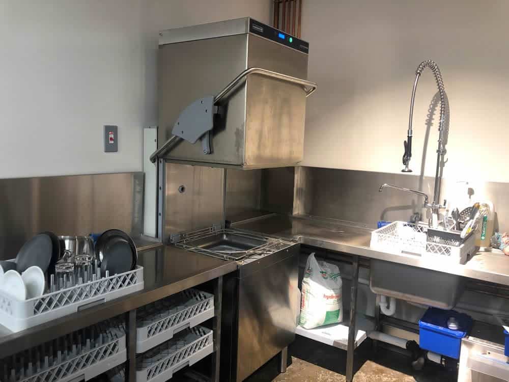 Maidaid dishwasher in the wash-up area at Macknade Fine Foods, Ashford