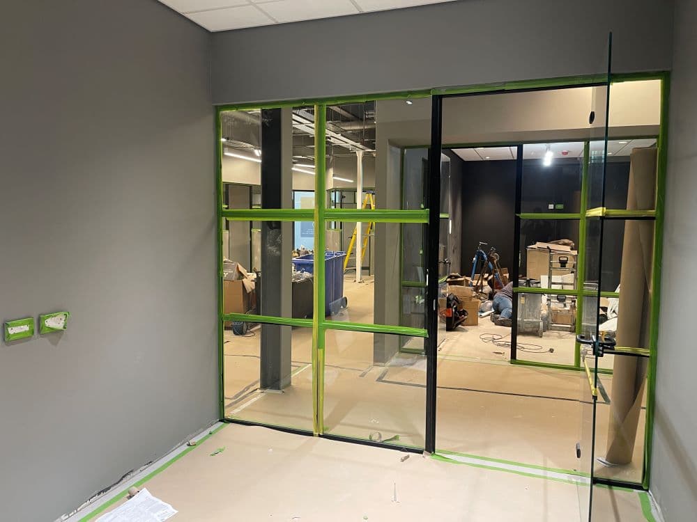 Glass partition wall dividing retail and office at The Snug, Ashford