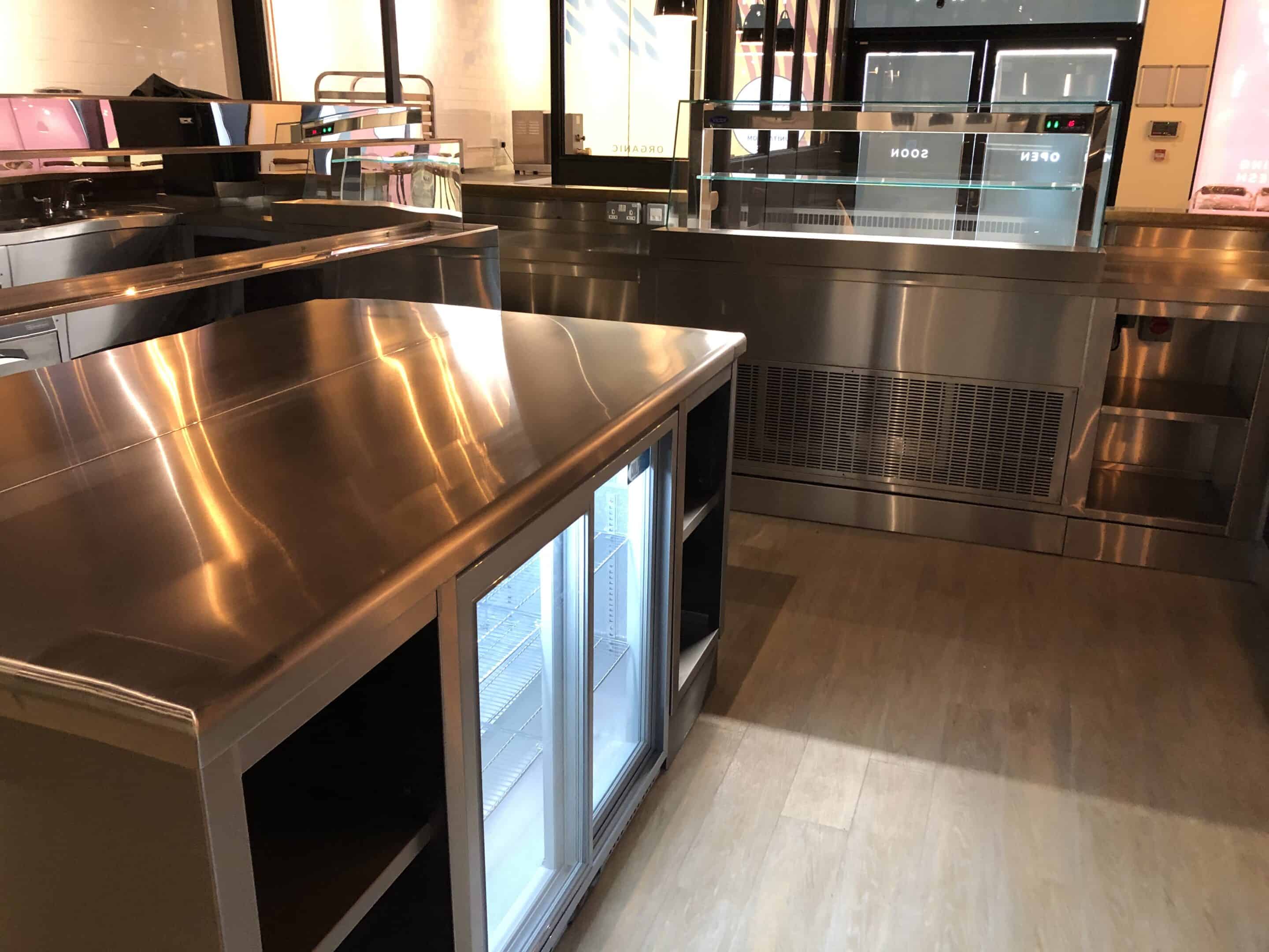 Front-of-house counter with display fridges at Unita Quattro